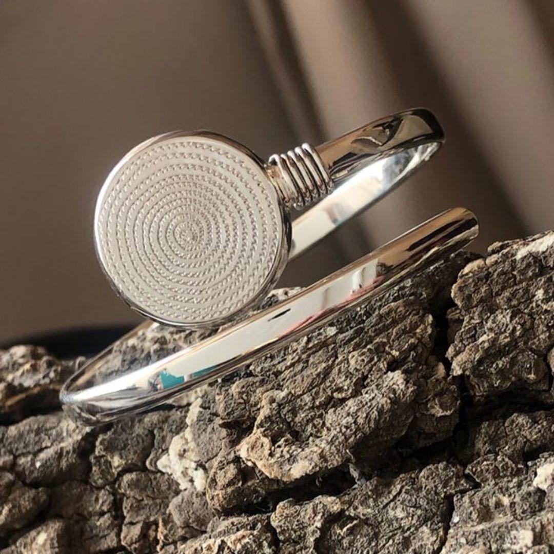 Sterling Silver Spiral Cuff Bangle with an Ndoro, a symbol of status from the ancient Kingdom of Great Zimbabwe