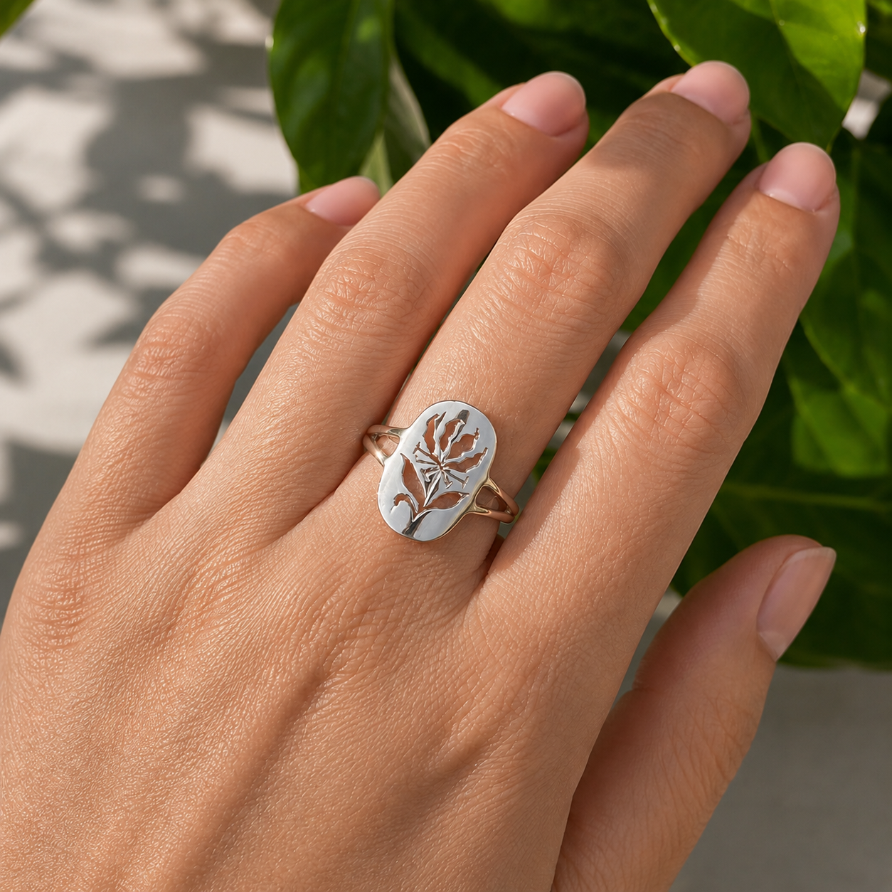 Woman wearing a handcrafted sterling silver Flame Lily split ring inspired by Zimbabwe's national flower.